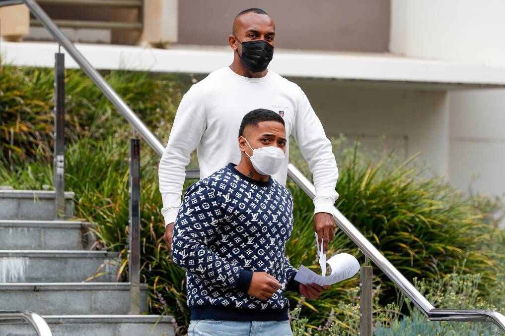 At liberty: Lorenzo Laemalu (blue jumper) and Manasa Nayacakalou (white jumper) walk free from Wollongong courthouse on Friday after being spared jail time for their role the brawl.