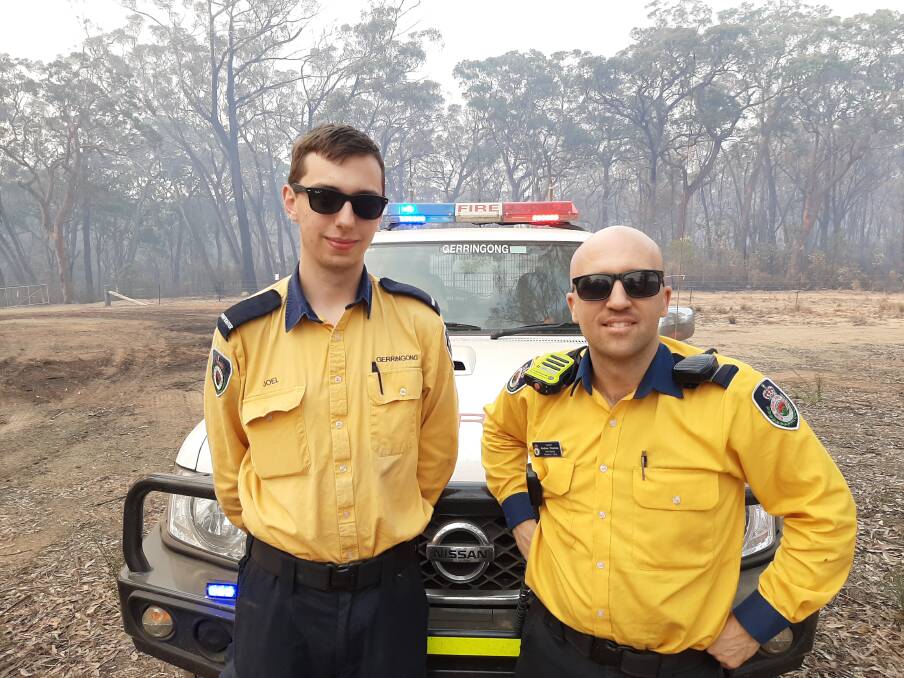 Gerringong RFS captain Andrew Downes (right) with a bridge member at the Green Wattle Creek Fire at High Range last week. Photo: Supplied