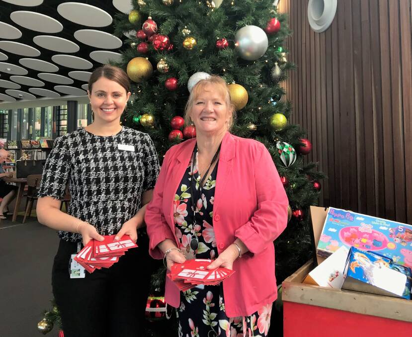 Festive spirit: Mayor Marianne Saliba and Shellharbour Club marketing coodinator Vanessa Mitrevska hope residents donate a small gift to brighten the face of a child.