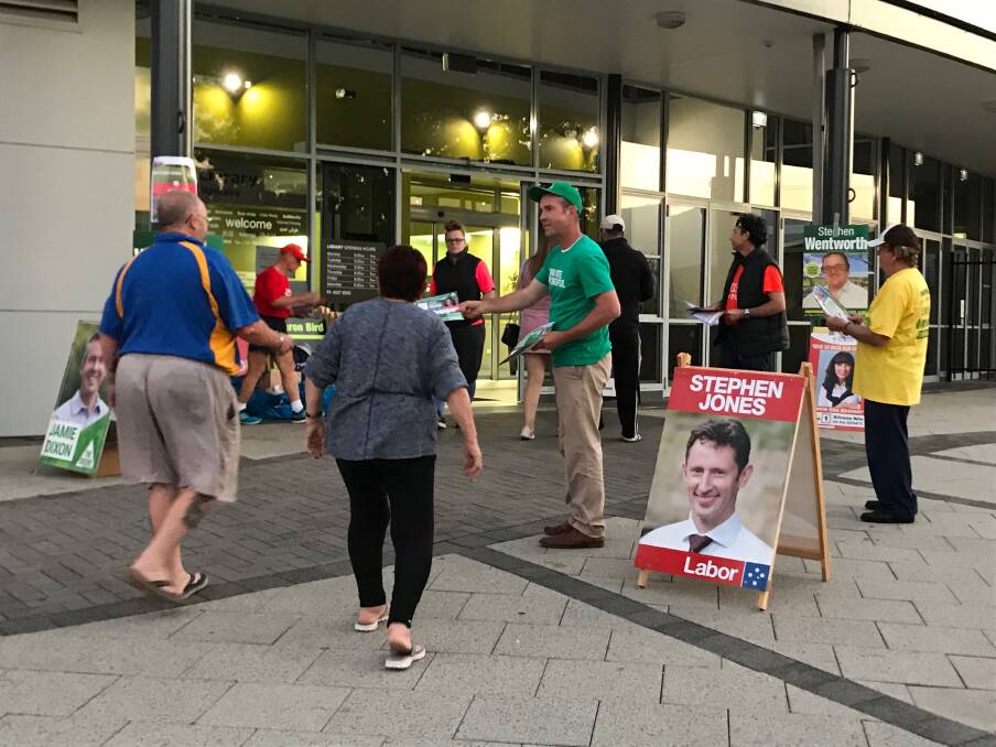 Voters: Greens candidate Jamie Dixon hands out how-to-vote pamphlets at Dapto Ribbonwood Centre on Saturday. Picture: Ashleigh Tullis