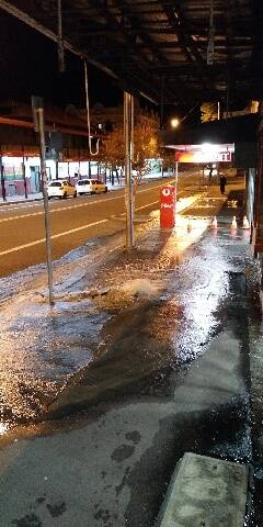 A main has burst on Wentworth Street, Port Kembla causing water to spill onto the road. Pictures: Greg Murphy