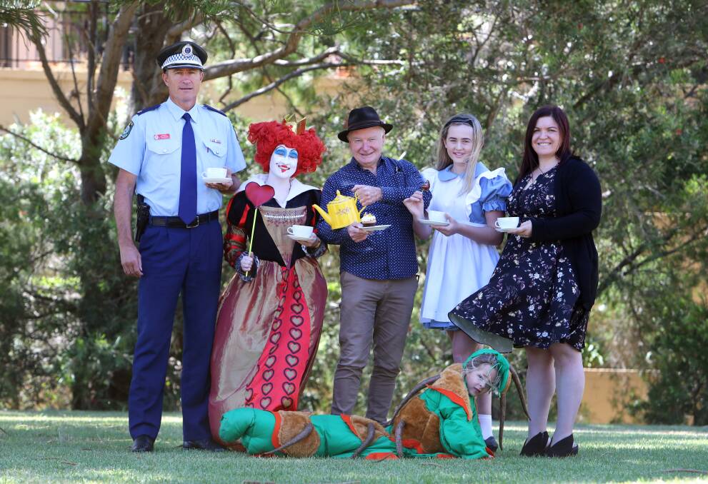 Police Chief Inspector Brad Ainsworth, Kasey Maher, Lord Mayor Gordon Bradbery, Violet Brighton and Acorn Lawyers general manager Simone Goodwin and Mia Klasson are looking forward to welcoming in the new year at Wollongong City Council's Alice in Wonderland-themed event. Picture: Sylvia Liber