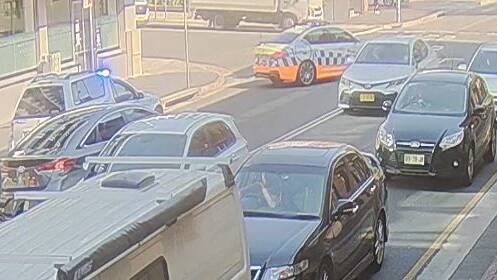 Police surrounded the car on Market Street, Wollongong. Picture: CCTV supplied
