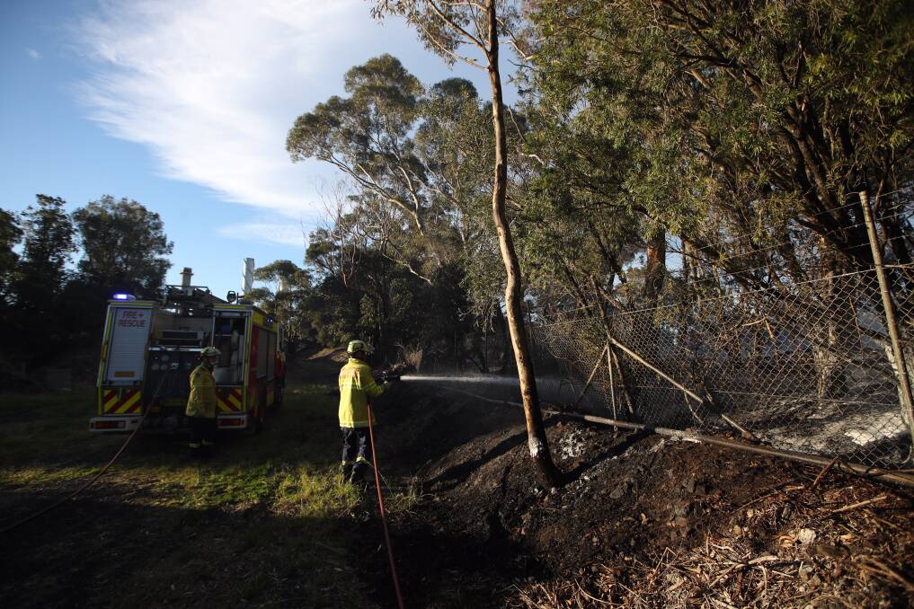 Firefighters mopping up after a grass fire. Picture: Adam McLean