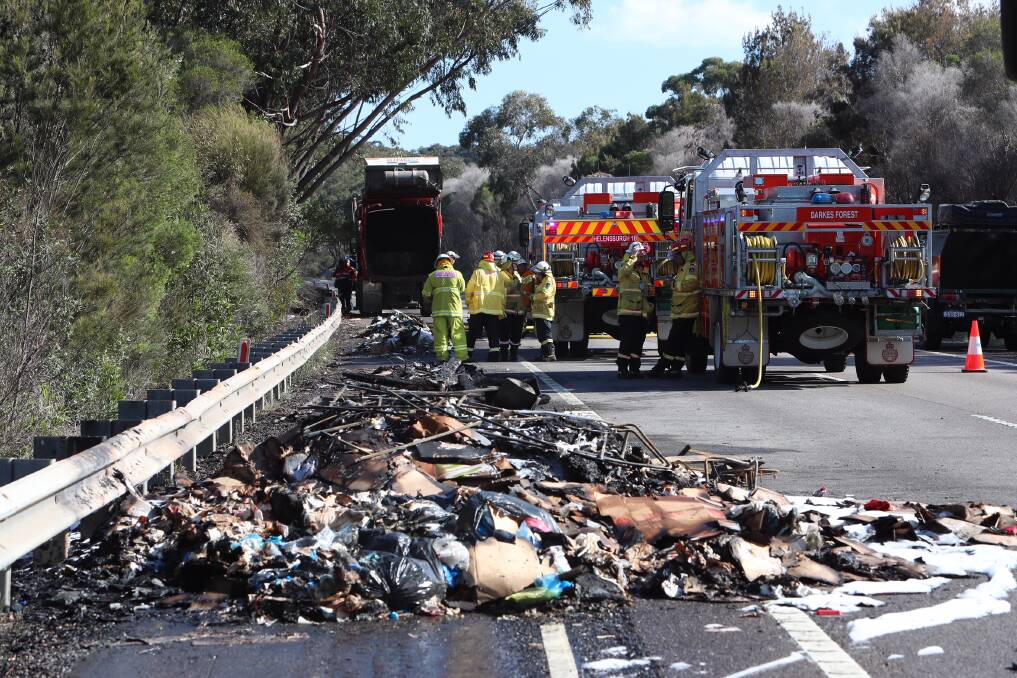 AFTERMATH: Crews cleaning up after the garbage truck fire on the M1 Princes Motorway. Picture: Sylvia Liber. 