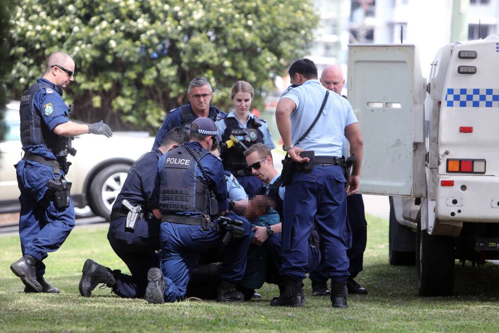 Several police officers descended on a man, arresting him, after he allegedly assaulted a number of victims on a Wollongong street. Picture: Adam McLean