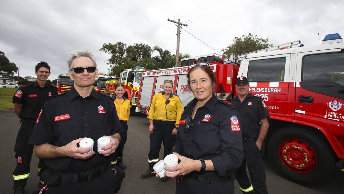 Fire and Rescue NSW and Rural Fire Service members, who attended a house blaze last week, returned to the street to talk about fire safety. Picture: Anna Warr