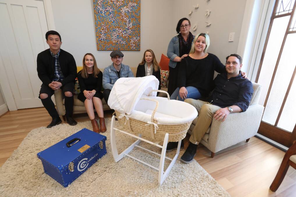 Support: Vodafone staff Arthur Kwok, Kieren Bentley, Chris Hands and Joanna Baxter with Tender Funerals volunteer Rebecca Collier and Geordi Penrose and Ashleigh Charlesworth with a donated cuddle cot. Picture: Robert Peet