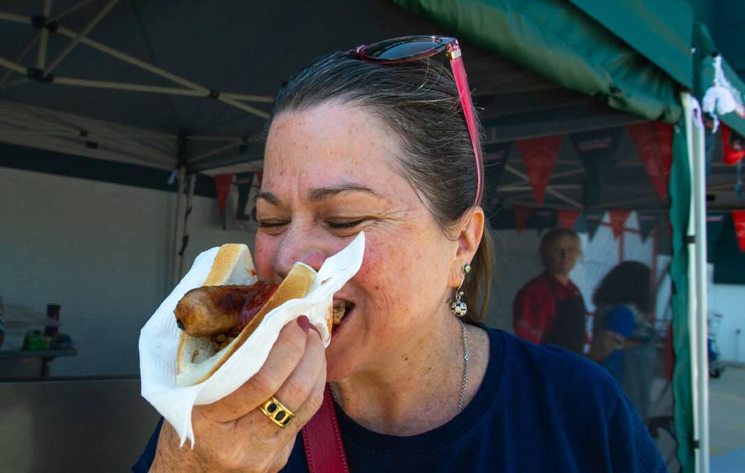 Tara Bucknall tucking into a sausage sanga as sausage sizzles return to Bunnings. File picture: Elesa Kurtz