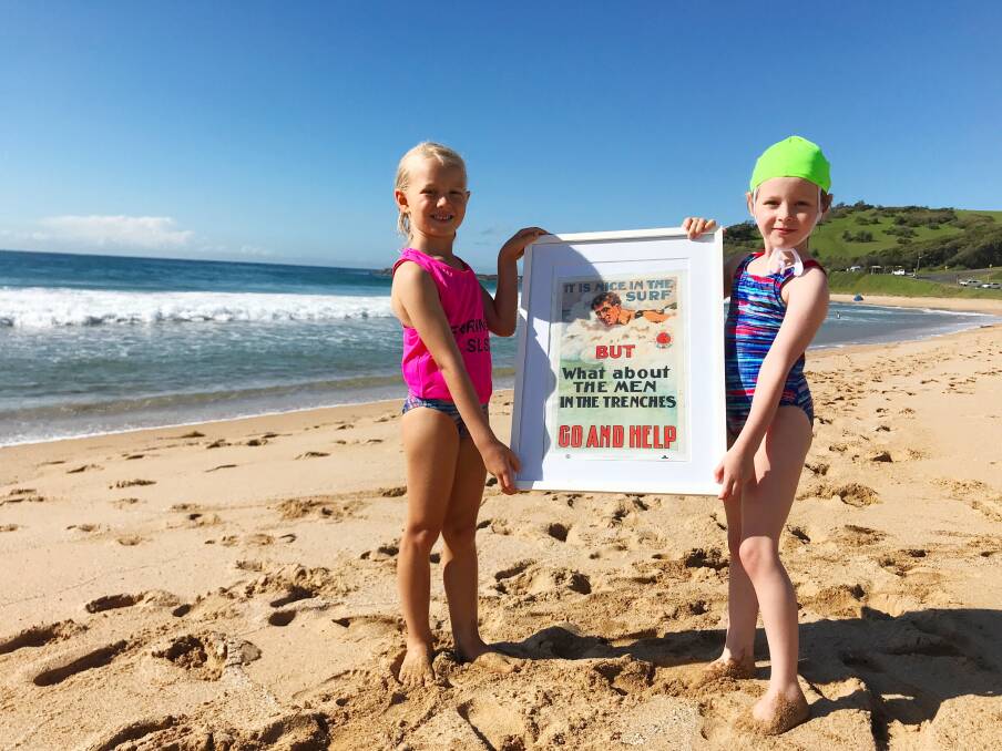 Adele Hawke, 6, and Lara Kolomeitz, 6, are Gerringong Surf Life Saving Club Nippers. The girls hold a WW1 recruitment poster targeting surf lifesavers. Picture: Ashleigh Tullis