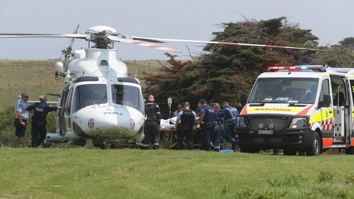 Hospitalised: The woman was loaded into the helicopter at a Gerroa park. She was in a serious but stable condition. Pictures: Robert Peet