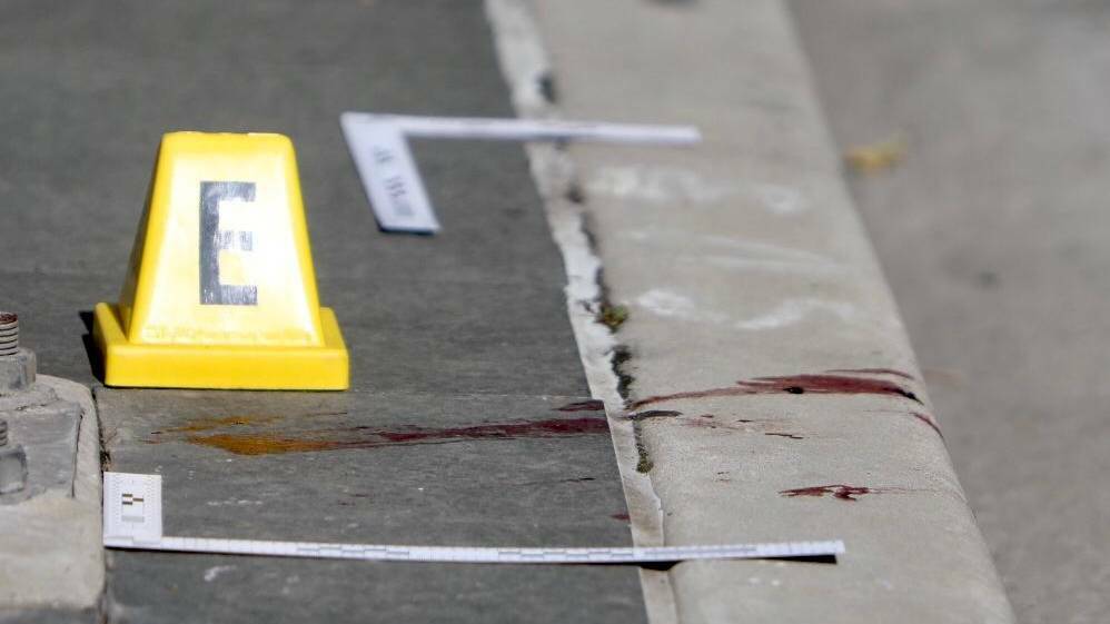  Blood remained on the footpath following a violent brawl.