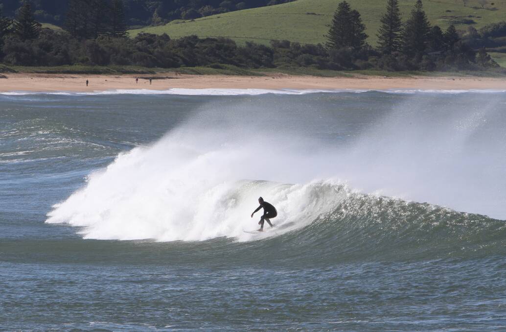 Calm before the wind: Surfers were still enjoying the waves early in the afternoon on Wednesday in Gerringong. Picture: Sylvia Liber