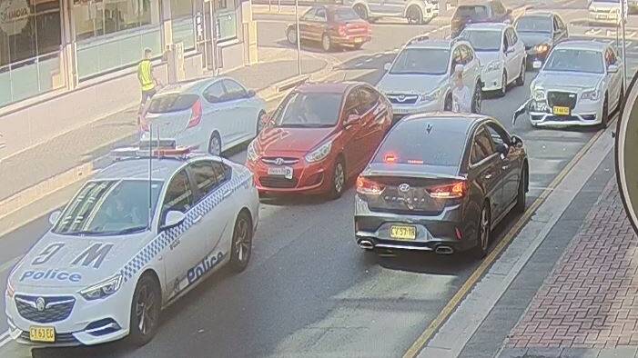 An unmarked police car was damaged in the collision. Picture: CCTV supplied