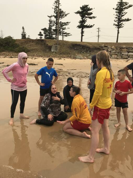 Lucky escape: Sandon Point life saving club members Lucy Bent-Genge and Eloise Lockhart along with president Ken Holloway helped save a woman caught in a rip on Sunday. Picture: Ken Holloway
