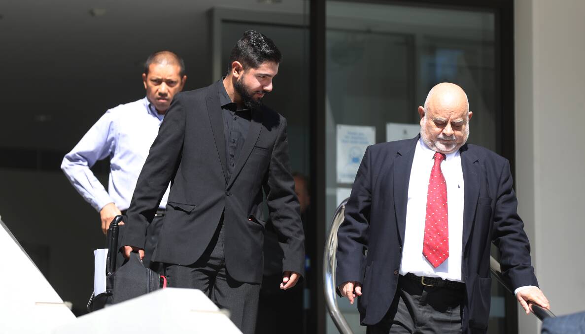 Charges defended: Mohsen Sleiman (middle) and his lawyer Roland Bonnici (right) left Wollongong Court House on Wednesday. Picture: Robert Peet