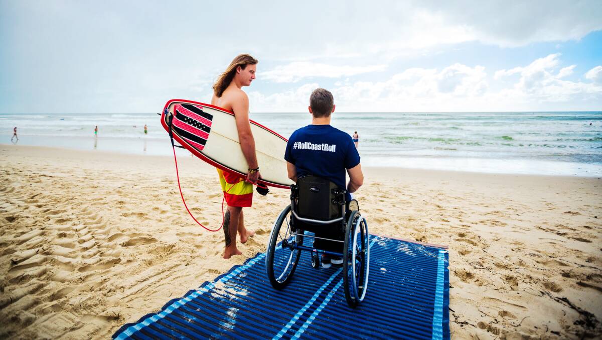 Councils around Australia have purchased beach wheelchairs and matting which allow people with disabilities to swim and access the sand. Picture: Chris Hopkins