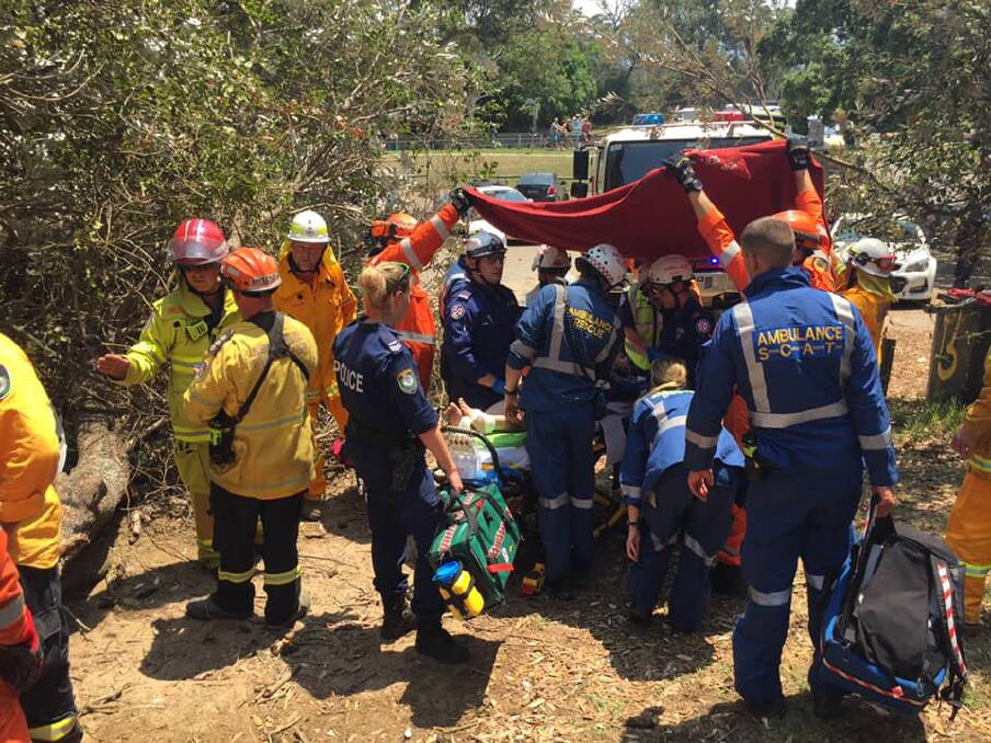 Freak incident: A woman was walking up a path after having a surf when the tree fell on her. Emergency service personnel treated her. Picture: NSW SES Kiama