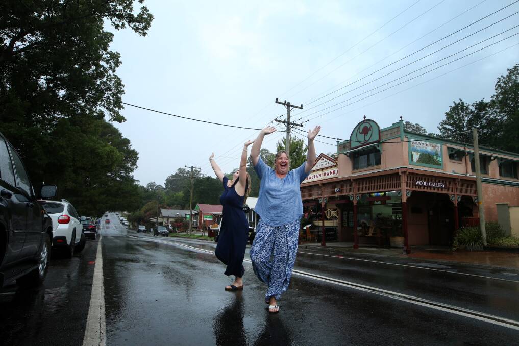 Nyrie Simpson and Chloe Palmer Simpson were so happy see some rainfall when they visited Kangaroo Valley. Picture: Sylvia Liber