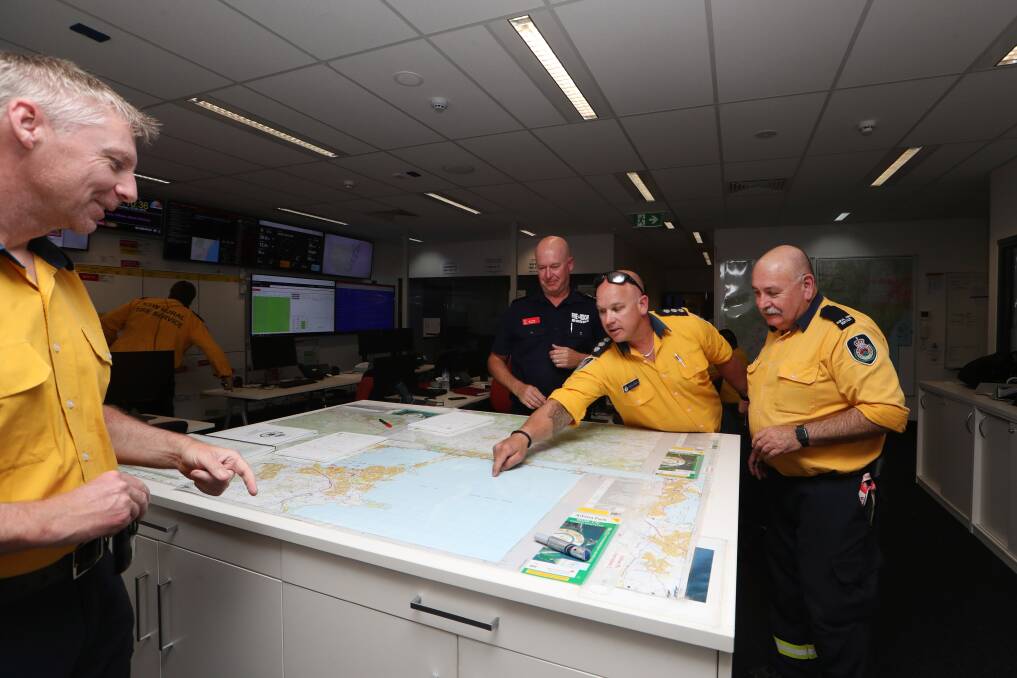 The Illawarra RFS senior management team, support agency liaisons, communications, community education and logistics crew members have been working hard to deploy volunteers and plan for bushfires. Picture: Sylvia Liber