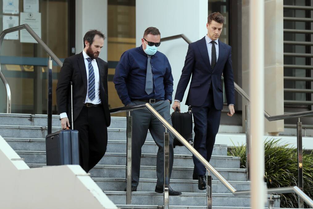 Lee Paterson (middle) leaves court with defence lawyers Will Tuckey and Matt Ward.