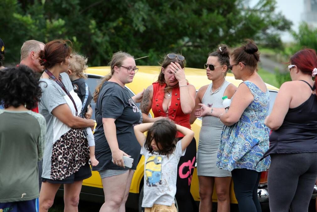 Raw grief: Friends and family console Adrian's Voltz's mother Andrea Ganitis when she visited the scene of the fatal crash. Pictures: Sylvia Liber
