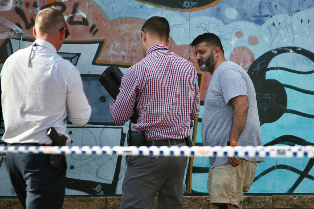 Thorough: Detectives spent Tuesday afternoon collecting evidence and talking to Sam Parekh about an armed robbery inside the Berkeley post office. Picture: Adam McLean