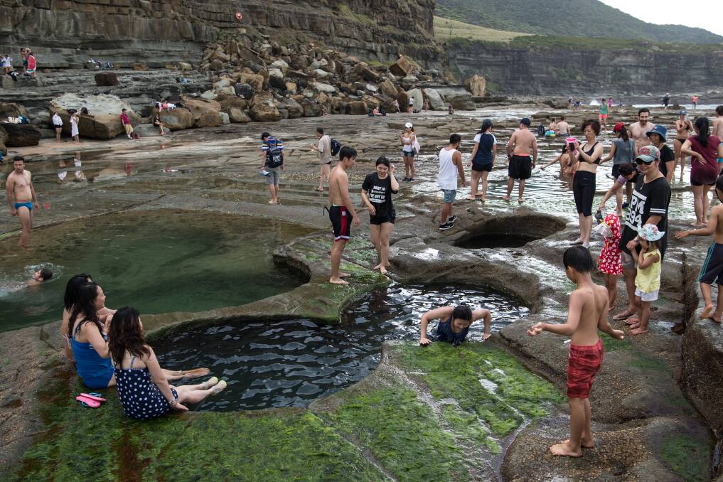 Insta-obessed: Tourists pose for photographs at the Figure 8 Pools in the Royal National Park. Picture: Wolters Peeters