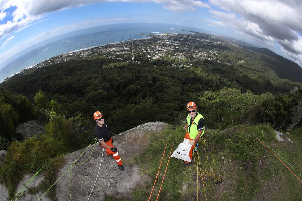 Helping out: SES members Nick Ayre (left) and Dave Bere were at Bulli Tops to collect rubbish over the escarpment for Clean Up Australia Day. Picture: Robert Peet