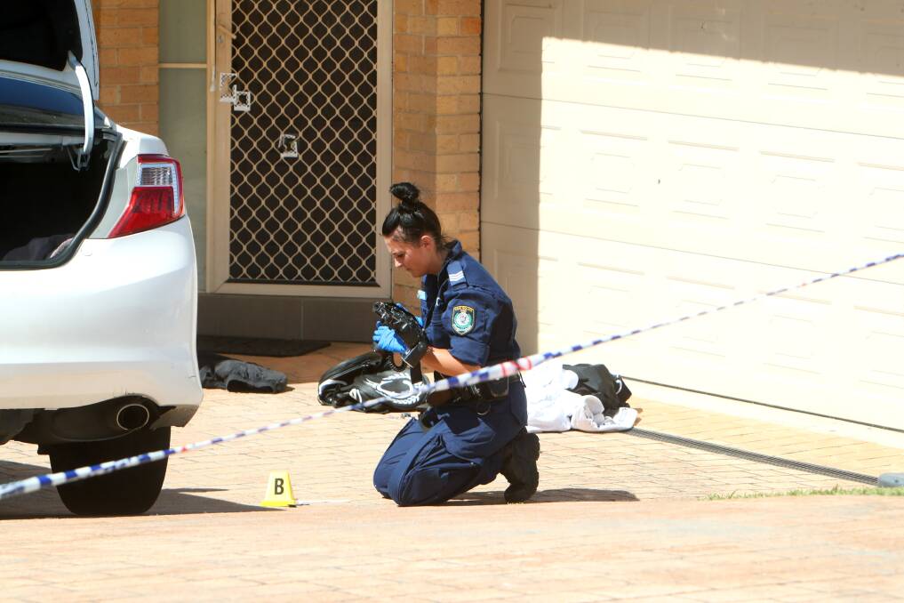 Crime scene officers collected evidence following the shooting at Denham Drive. Picture: Sylvia Liber