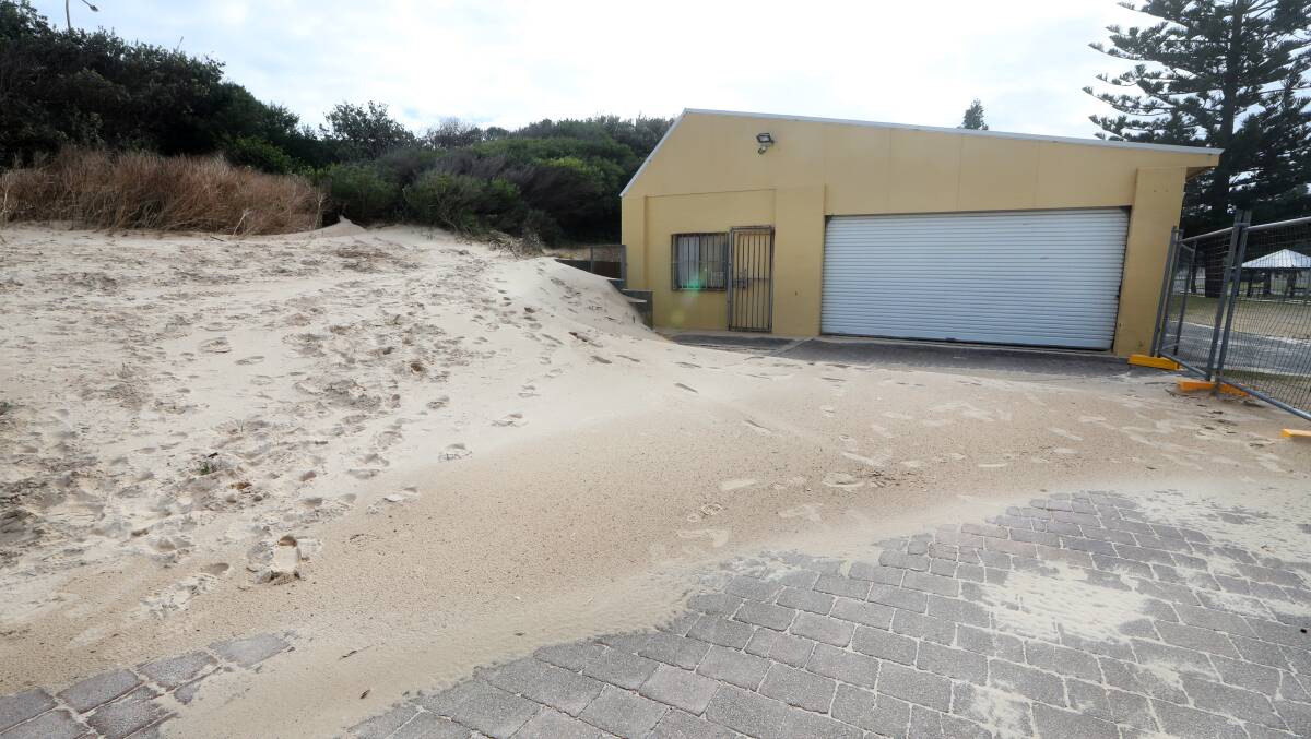 As part of council's dune stabilisation strategy, sand was moved from Port Kembla Beach. Wind dumped it back in front of the surf life saving shed. Picture: Sylvia Liber