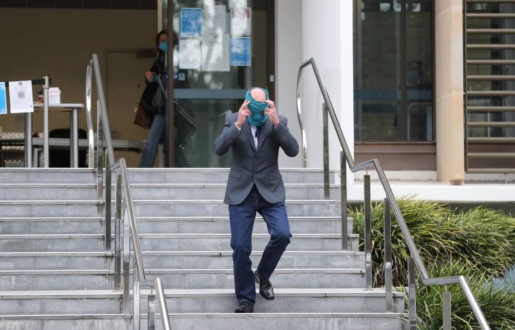 Arthur Moulton covered his face as he left Wollongong Local Court on Tuesday.