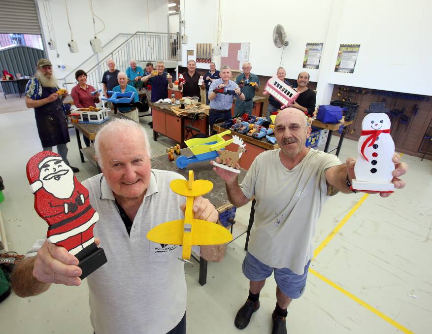 Christmas gifts: Kevin Blackett and Grahame Wunderlich and other members of the Wollongong Men's Shed have made toys for the Wollongong Council's Giving Tree Appeal. Picture: Robert Peet