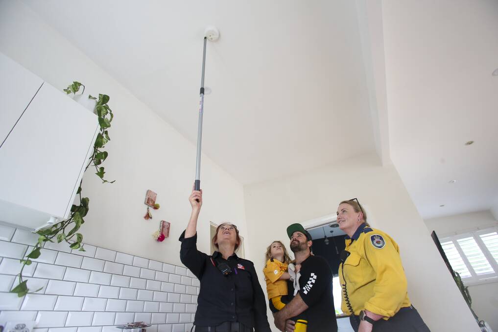 Firefighters checked and installed smoke alarms in people's homes as part of a community initiative on Saturday. Picture: Anna Warr