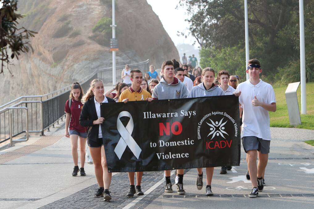 Dozens gathered for the annual walk at North Wollongong Surf Life Saving Club to raise awareness of the fight against domestic violence. Pictures: Sylvia Liber