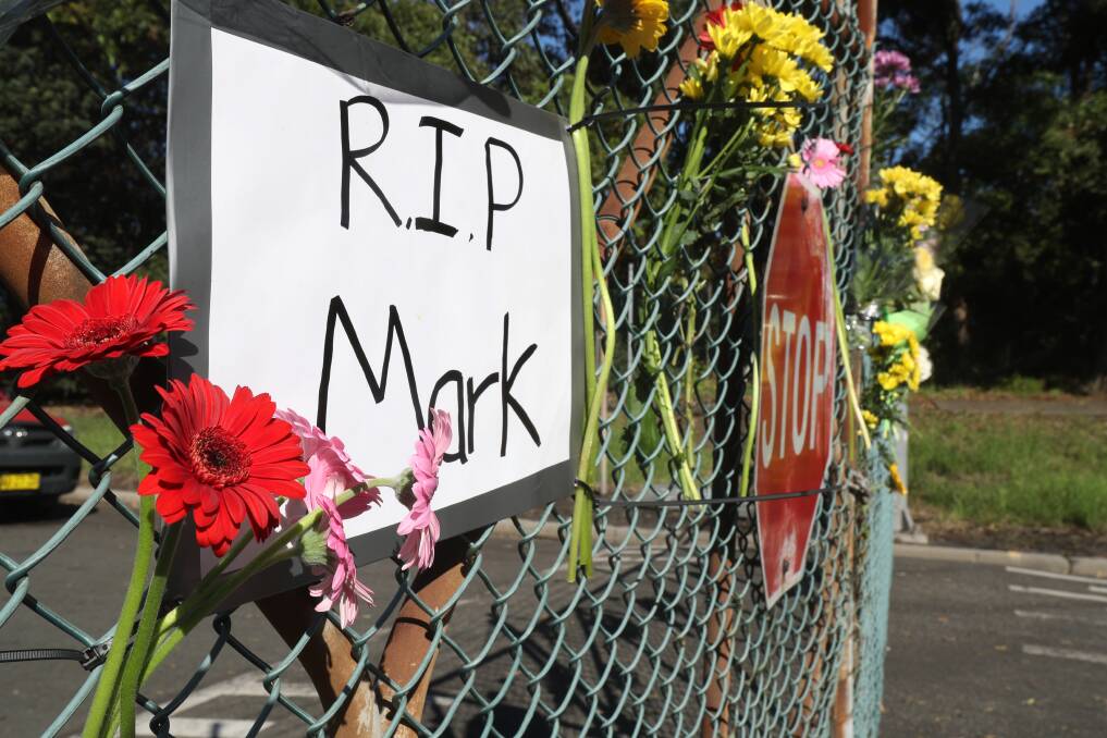 RIP: PKCT workers, who are locked out, laid flowers at the terminal gate in honour of their colleague Mark Roberts. Pictures: Robert Peet