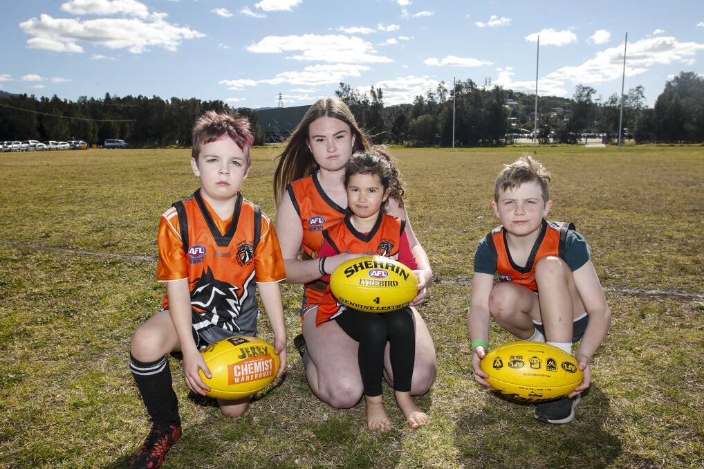 Frustrated: Dapto AFL Club players Kian Sunderland, Jorja Yates, Isla Lawson and Tadhg Sunderland want a promised club ground in Dapto to be built. Picture: Anna Warr