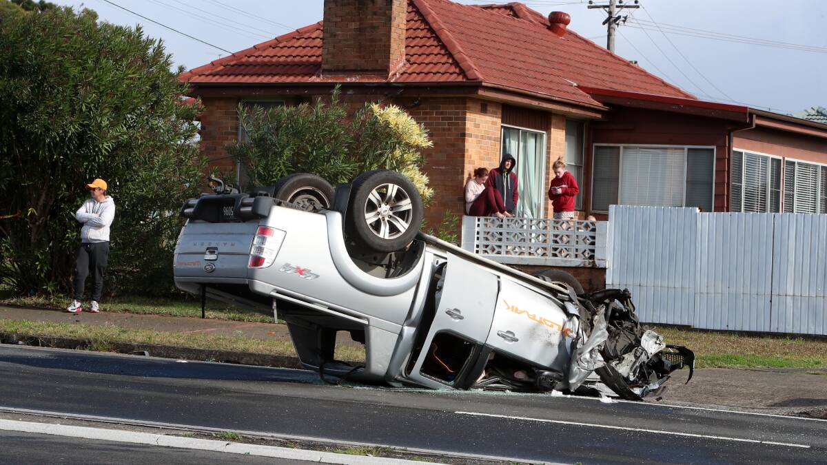 The driver of a ute had to be removed from after his car flipped and landed on its roof. Pictures: Sylvia Liber