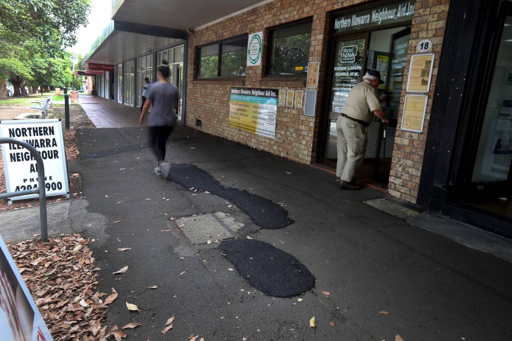 Dangerous: Wollongong City Council repaired the Walker Street footpath but did not level out the tarmac. Residents and business owners fear it is a trip hazard. Picture: Robert Peet