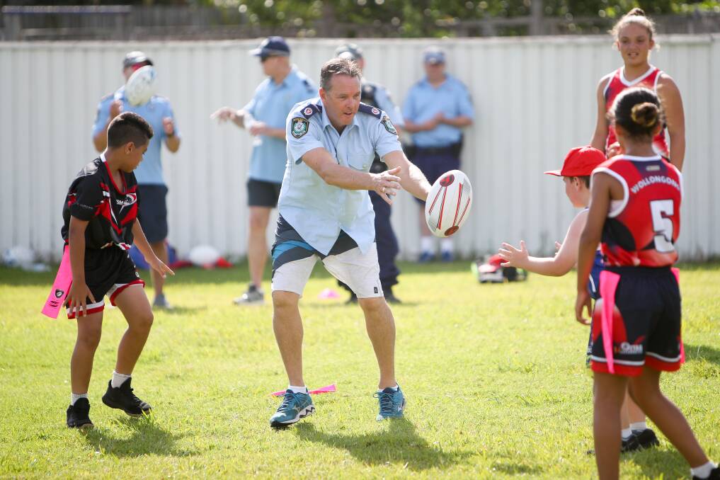 Goals: Wollongong Superintendent Chris Craner playing touch football with kids at Bellambi for the Rise Up program. Picture: Adam McLean