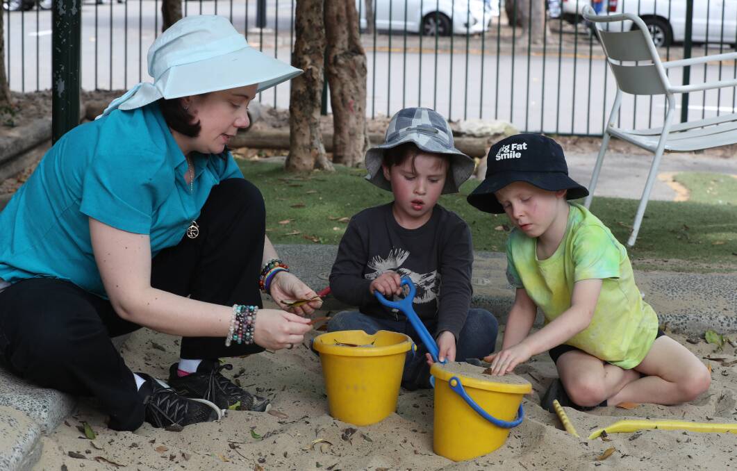 Play time: Big Fat Smile Corrimal director Kate Ashelford with Lachlan and Matthew. Picture: Robert Peet