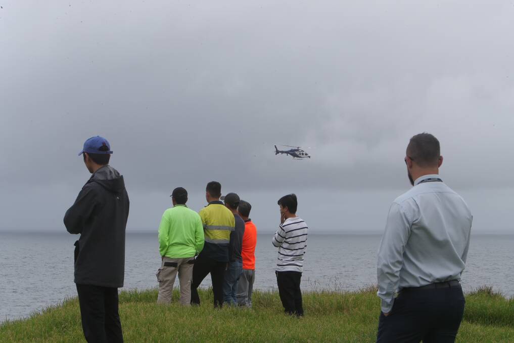 Police and surf life saving crews including a rescue helicopter are searching for a missing rock fisherman off the coast of Kiama. Pictures: Sylvia Liber