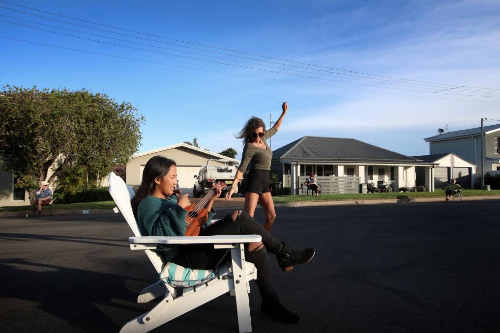 Fun: Adelaide Place residents, including organiser Loretta Cuda and daughter Kiki, enjoyed a driveway party while adhering to social distancing rules on Sunday afternoon. Picture: Sylvia Liber