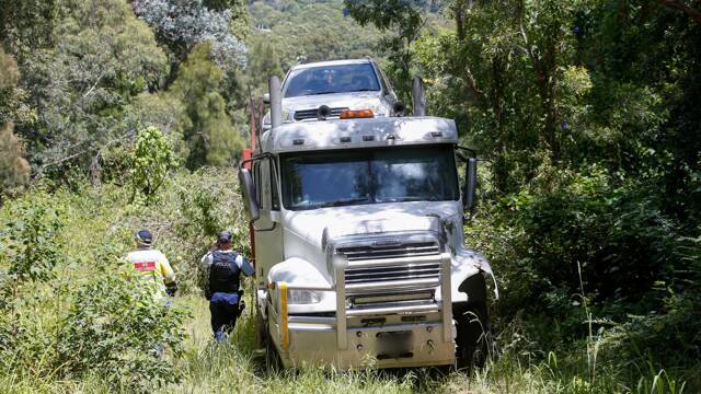 A truck has come to a stop high up in the bush of a safety ramp after it lost its brakes and collided with a car. There were long traffic delays. Pictures: Anna Warr