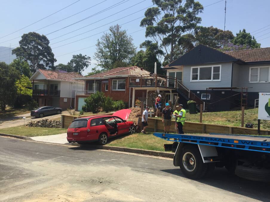 A car has crashed into a fence on Bukari Street in West Wollongong on Friday. Picture: Robert Peet