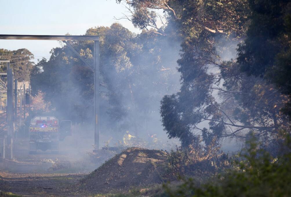 Wind has caused a smoky haze at Corrimal as firefighters worked to extinguish a grass fire near the cokeworks site. Picture: Adam McLean