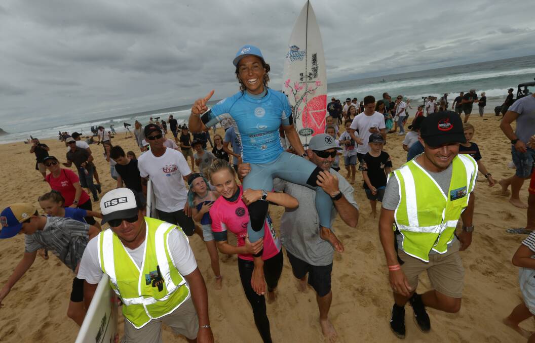 CHAMPION: Sally Fitzgibbons is chaired up Merewether beach after taking out the Surfest women's final on Sunday. Picture: Jonathan Carroll