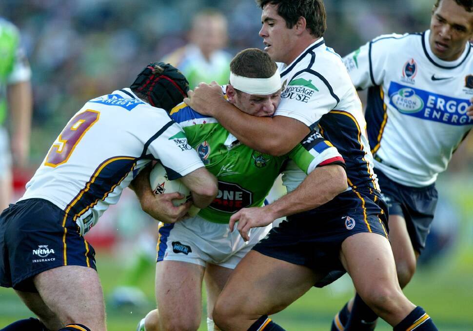 Raiders vs Broncos: Josh Miller rampages towards the Broncos line while Michael Ryan and Corey Parker desperately try to defend. Photo: Ben MacMahon.