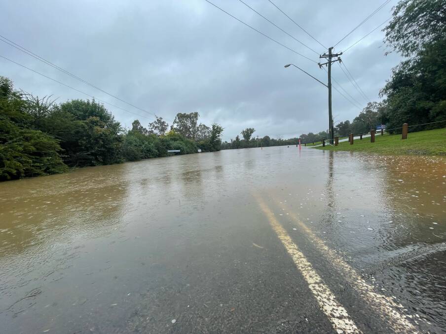 Water over the road at Macquarie Grove Bridge in Camden on Thursday afternoon. Picture: Simon Bennett