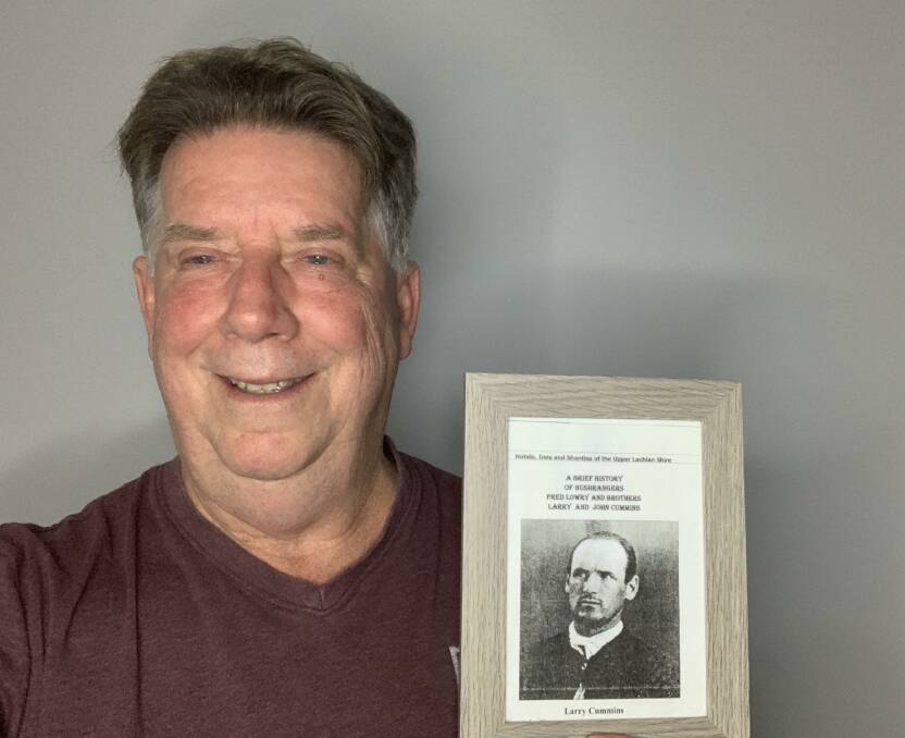 Author Peter Long with a portrait of his great-grandfather, bushranger Larry Cummins. Picture supplied.